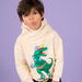 Sweat à capuche blanc crème à motif dinosaure